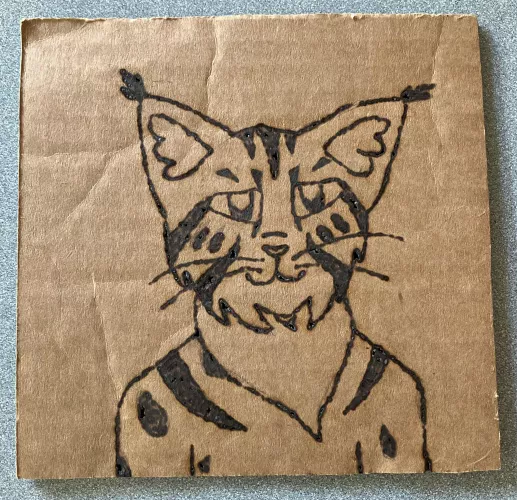 My fursona burned into cardboard (I used a magnifying glass and the sun, nothing fancy)