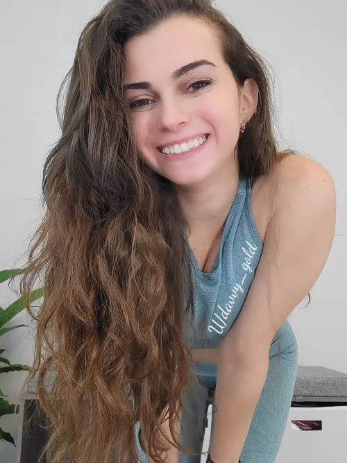 A petite girl with a big smile and some crazy hair!