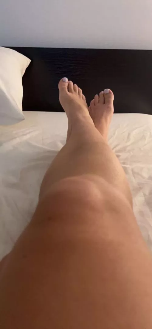 Right now in bed. Would you kiss my feet and legs?