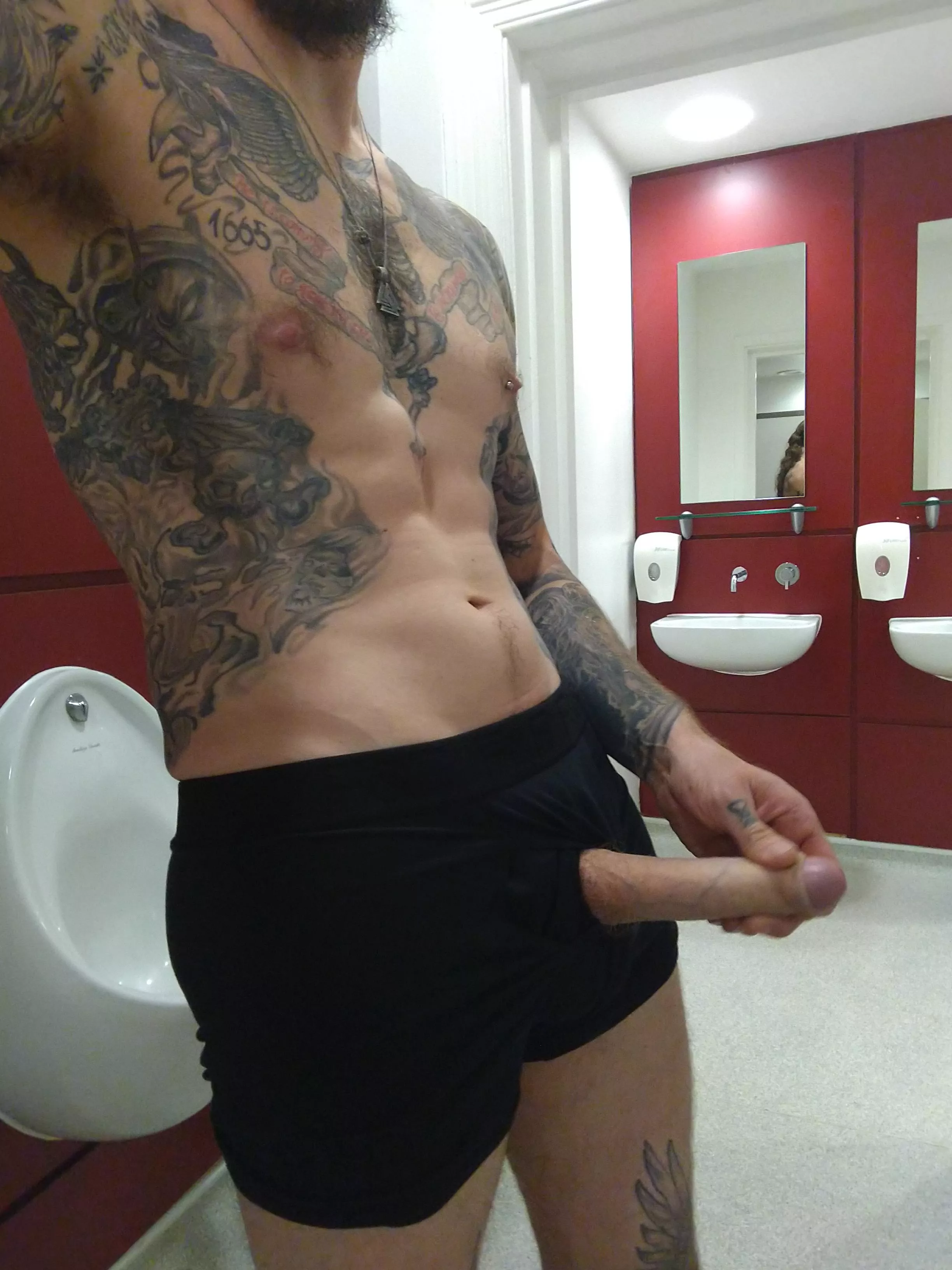 Beard and boner on display in a public restroom.