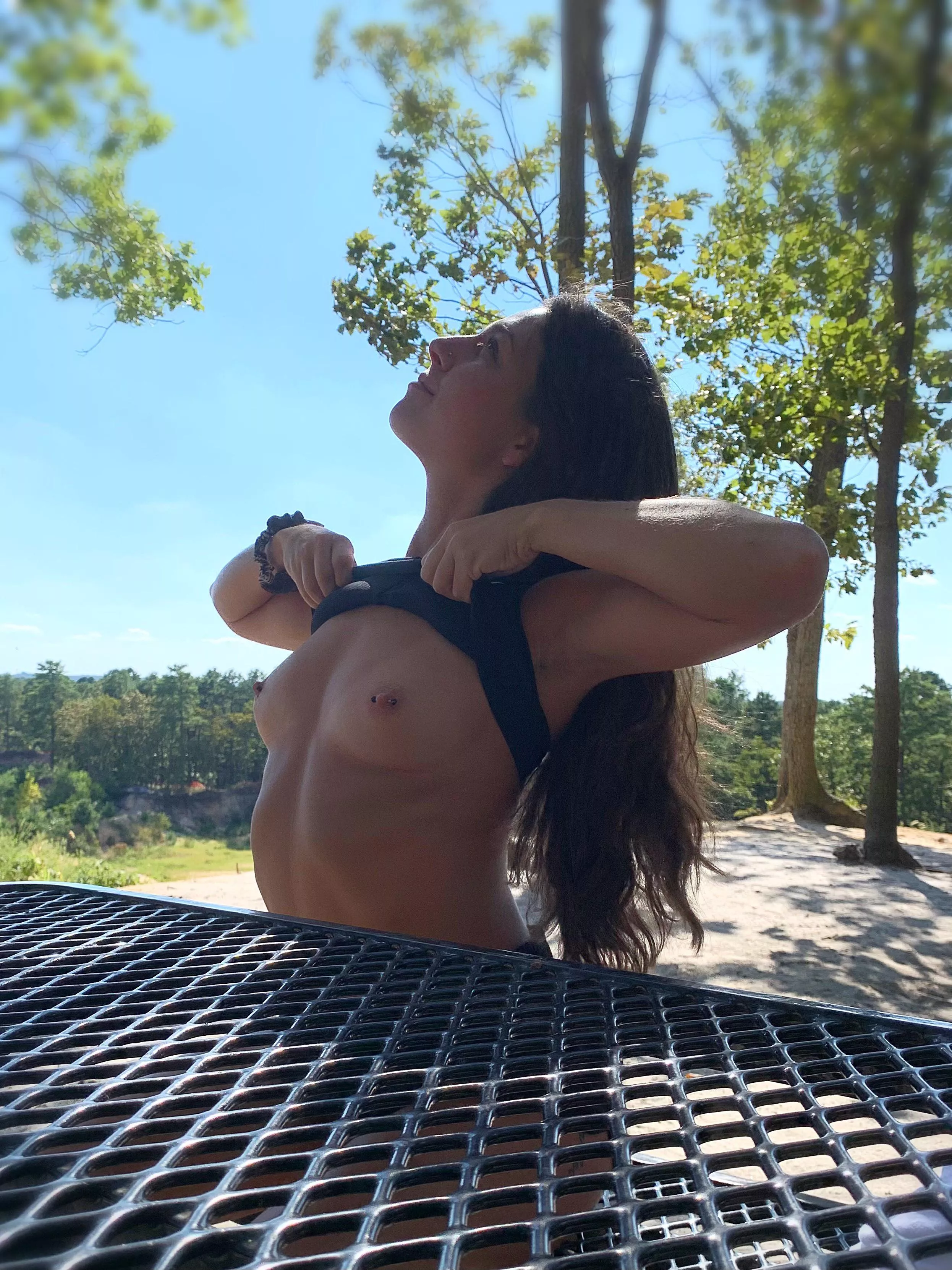 Lifting my top at a picnic table Lifting my top at a picnic table