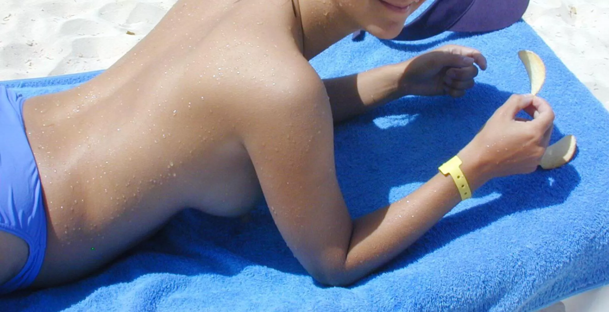 Propped on elbows at the beach - great side view. Propped on elbows at the beach - great side view.