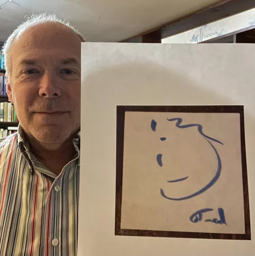 Here I am with a self-portrait I drew. (It’s how I see myself.)